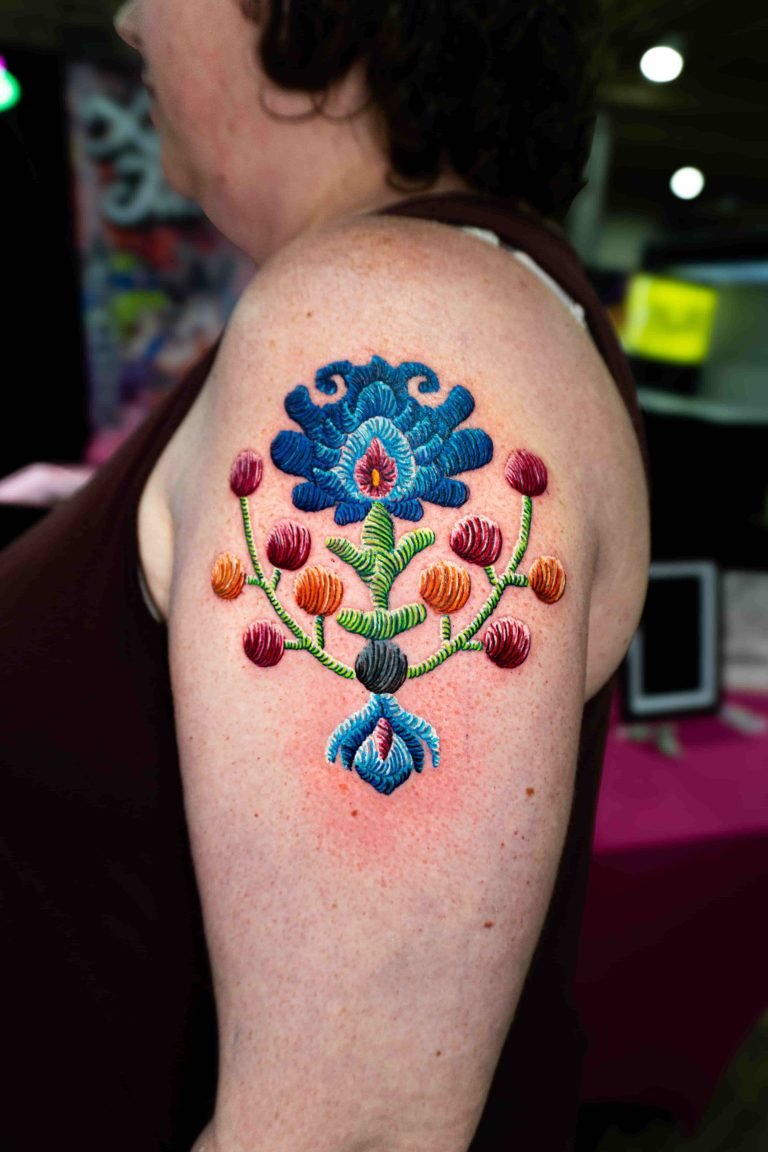 Embroidery tattoo of a Polish flower in patch style with vibrant colors